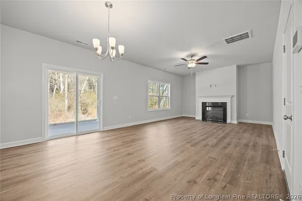 a view of a kitchen with a sink and wooden floor