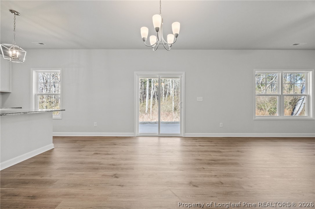 155 Michter Street Vass, NC 28394 - Photo 31 of 46 a view of an empty room with a window and wooden floor