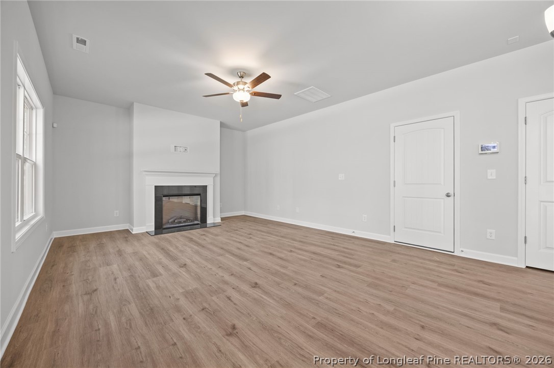 155 Michter Street Vass, NC 28394 - Photo 34 of 46 a view of empty room with wooden floor and fan