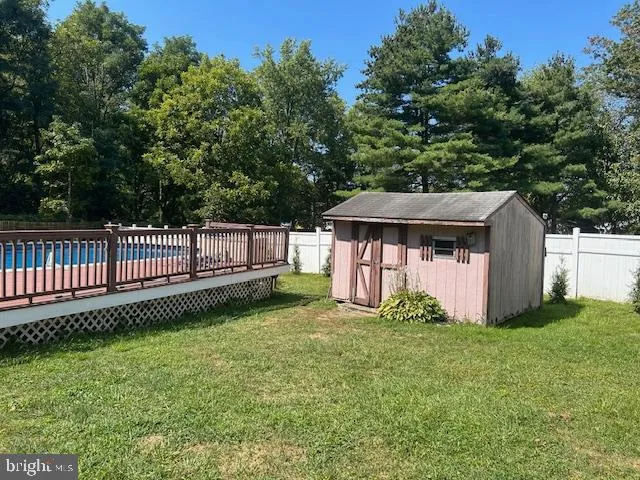a view of a house with a yard and fence