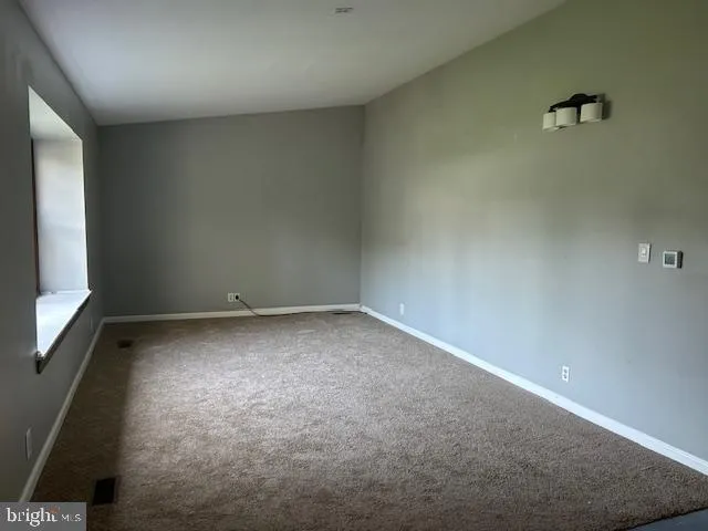an empty room with a windows