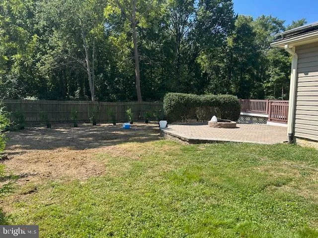 a swimming pool with outdoor seating and yard