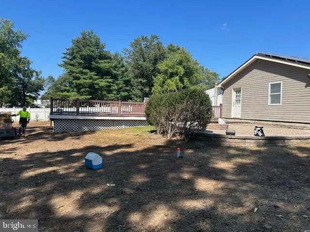 a view of a house with yard and sitting area