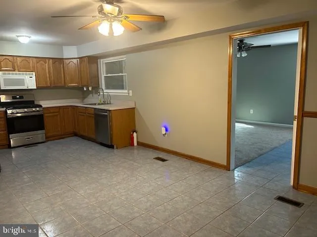 a kitchen with a refrigerator and a sink