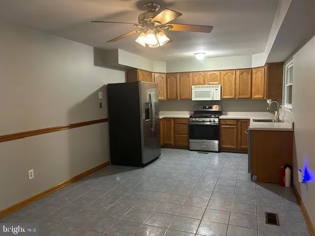 a kitchen with stainless steel appliances granite countertop a refrigerator a stove a sink dishwasher and a refrigerator