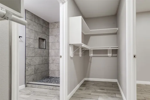 a bathroom with a glass shower door