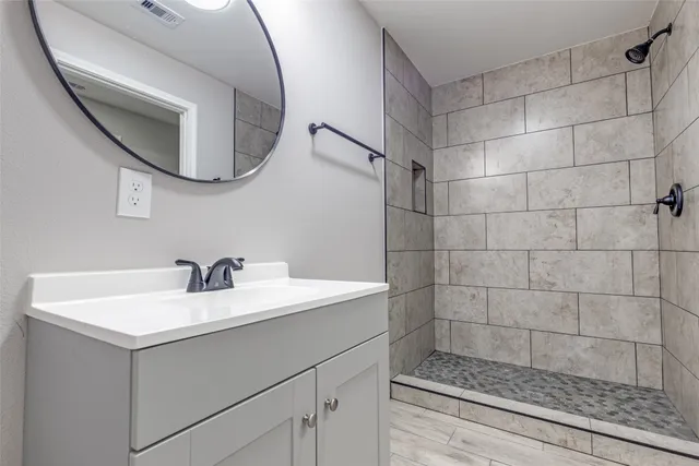 a bathroom with a sink mirror and vanity