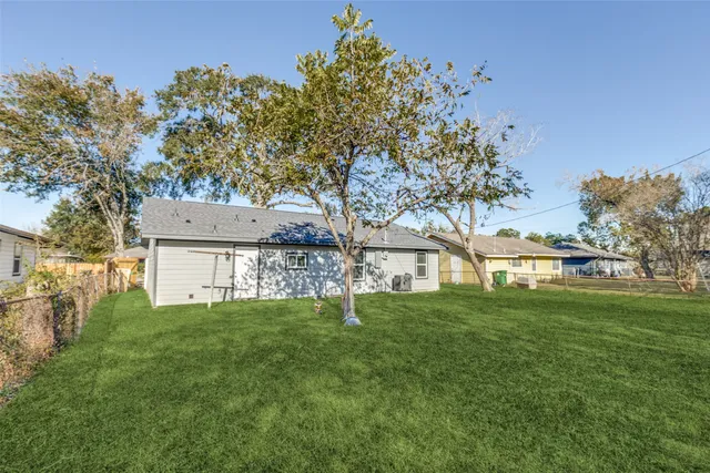 a garden with trees in front of it