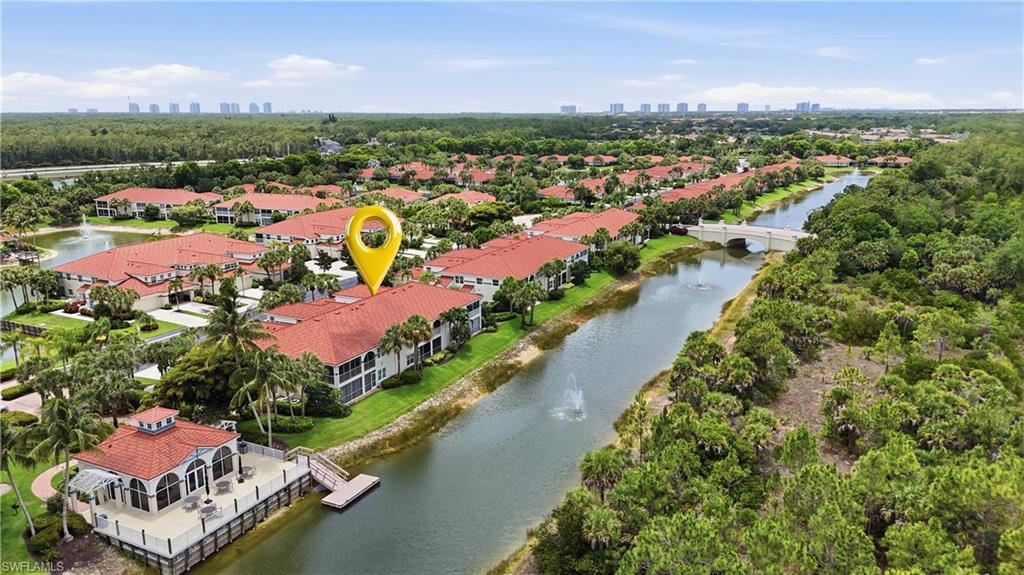 10871 Crooked River Road, Unit 202 Estero, FL 34135 - Photo 37 of 46 an aerial view of a city with lots of residential buildings ocean and mountain view in back