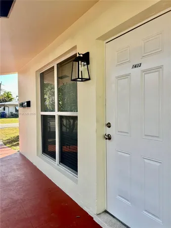 a view of a livingroom with a fireplace and a window