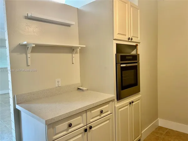 an empty room with fan and windows