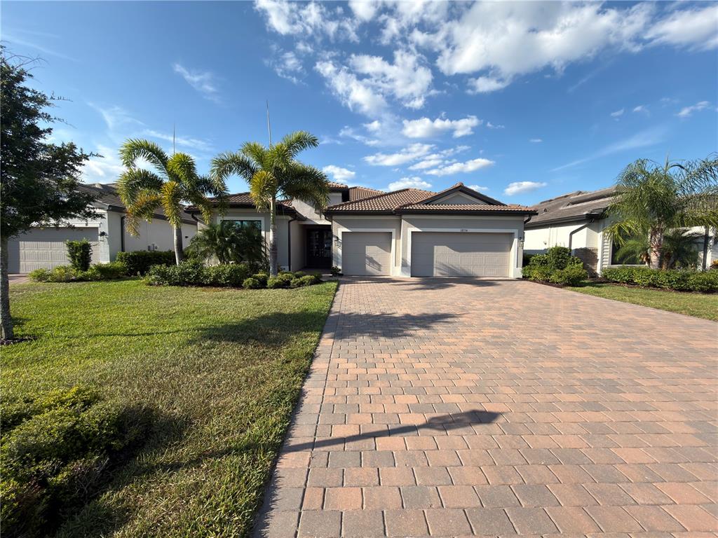 18334 Ridgeline Drive Estero, FL 33928 - Photo 1 of 30 a front view of a house with garden