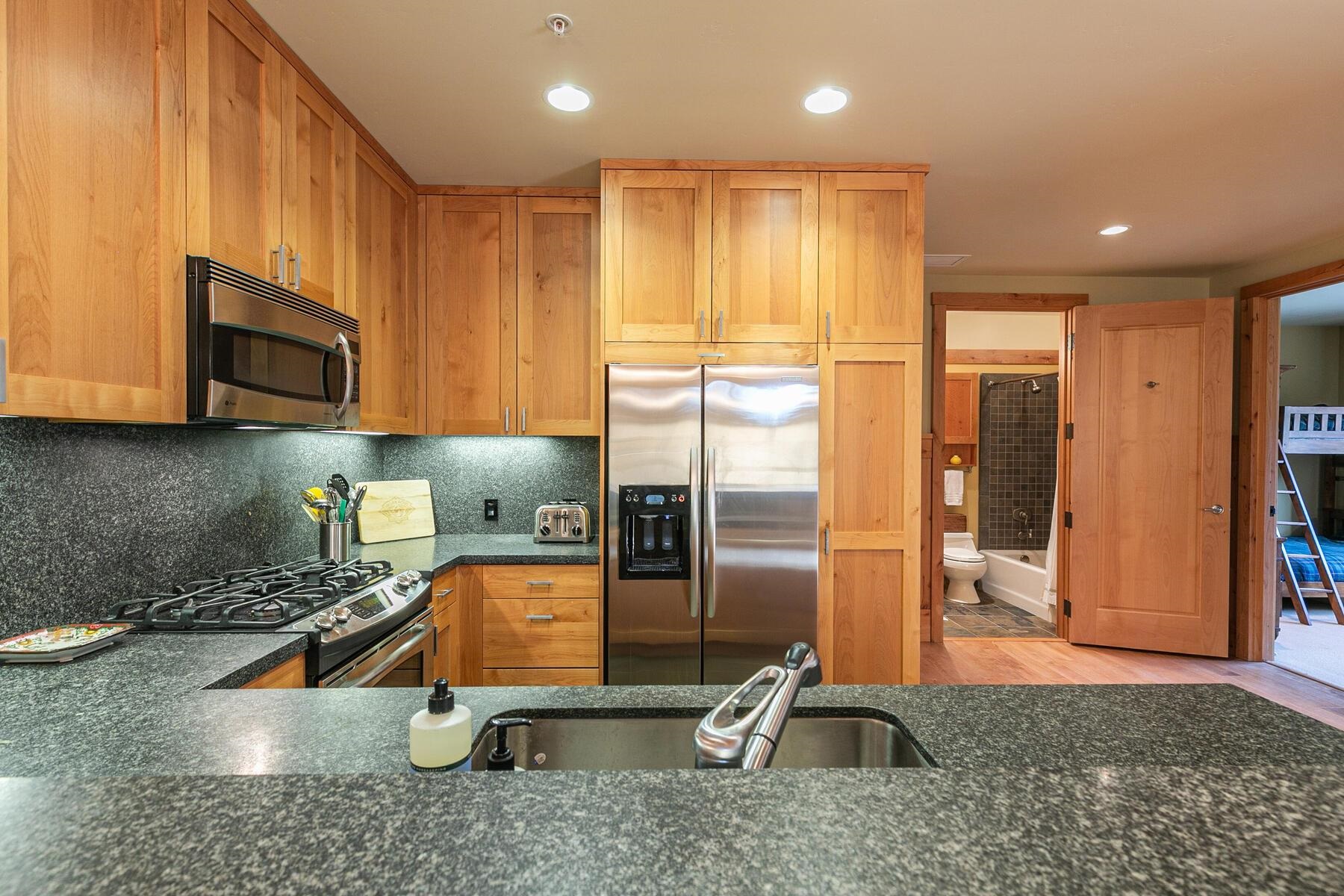 600 Sugar Bowl Road, Unit 211 Truckee, CA 96161 - Photo 13 of 21 a kitchen with a refrigerator a sink and cabinets