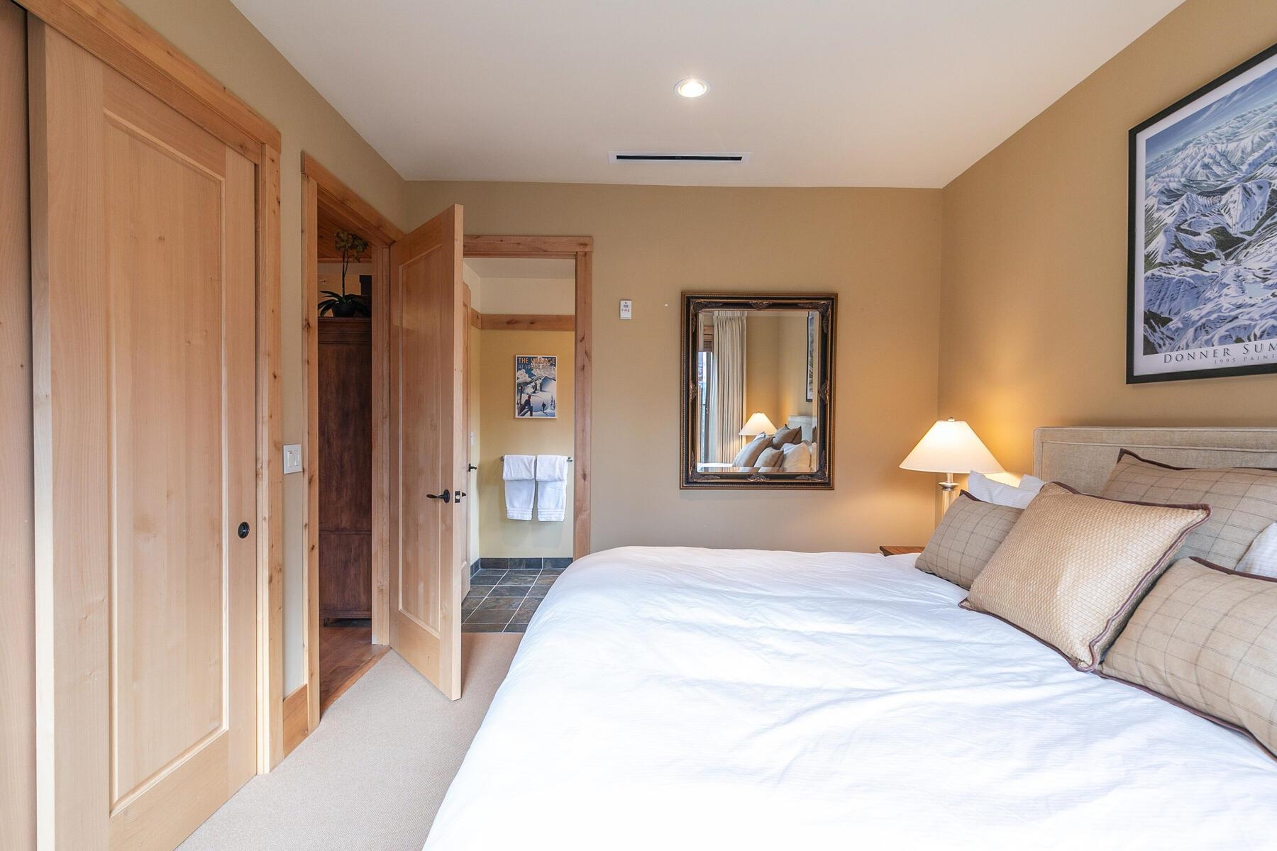 600 Sugar Bowl Road, Unit 211 Truckee, CA 96161 - Photo 8 of 21 a bedroom with a bed and a chandelier
