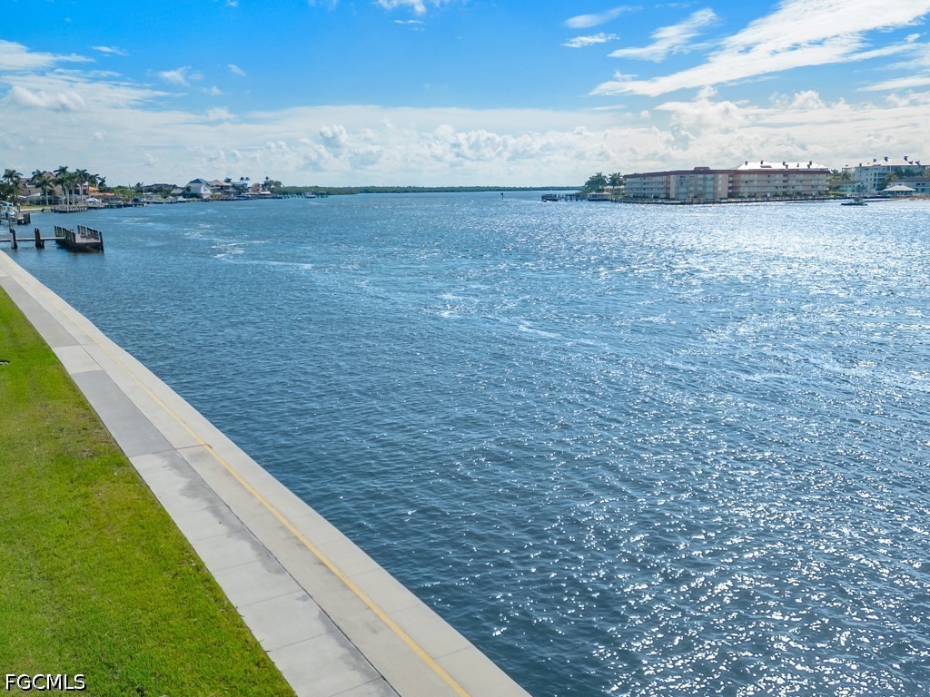 232 La Peninsula Boulevard, Unit 232 Naples, FL 34113 - Photo 34 of 44 a view of an outdoor space and a lake view