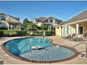 1900 Scofield Ridge Parkway, Unit 4701 Austin, TX 78727 - Photo 22 of 27 A community pool offers refreshing recreation alongside charming residential architecture.