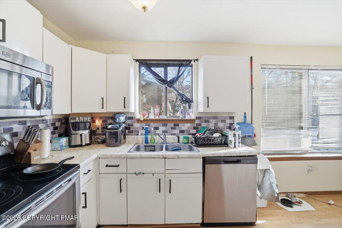 518 Wales Court Bushkill, PA 18324 - Photo 3 of 18 a kitchen with stainless steel appliances a sink and cabinets
