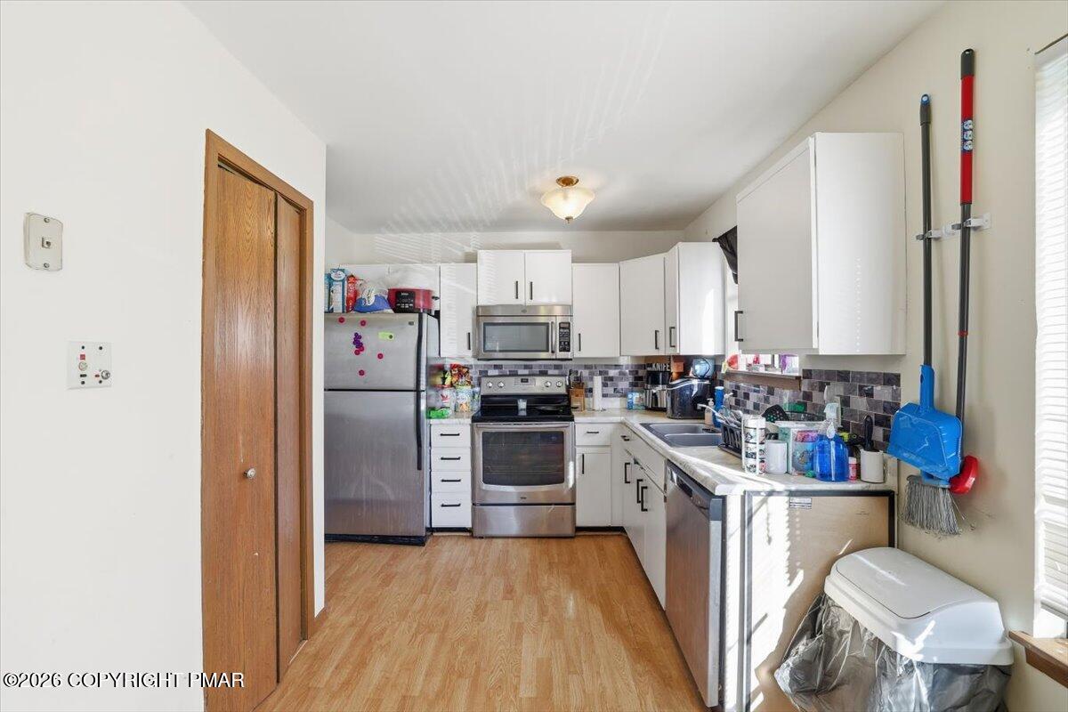 518 Wales Court Bushkill, PA 18324 - Photo 4 of 18 a kitchen with a refrigerator stove and wooden cabinets
