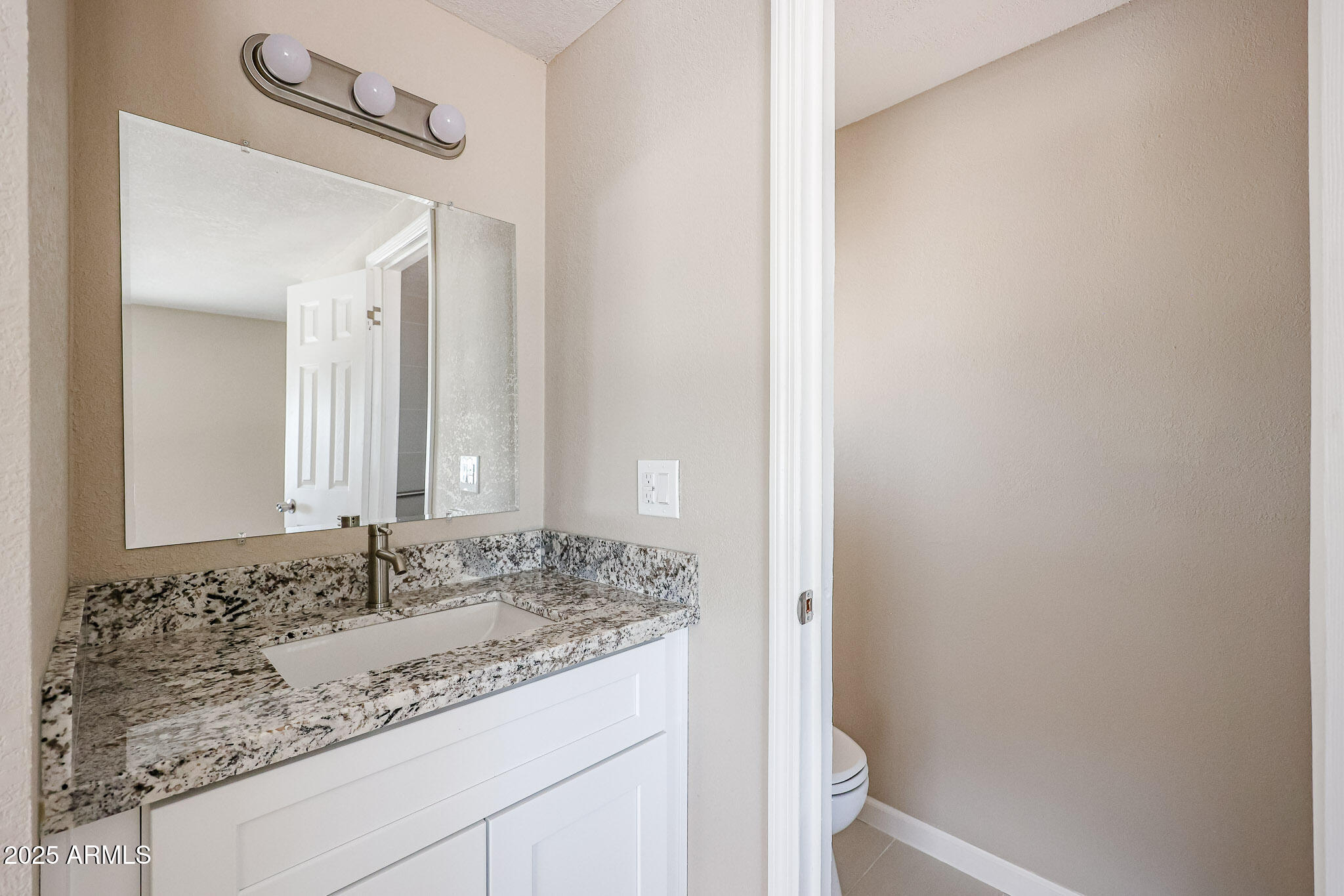 8600 East Broadway Road, Unit 53 Mesa, AZ 85208 - Photo 15 of 29 a bathroom with a granite countertop sink and a mirror