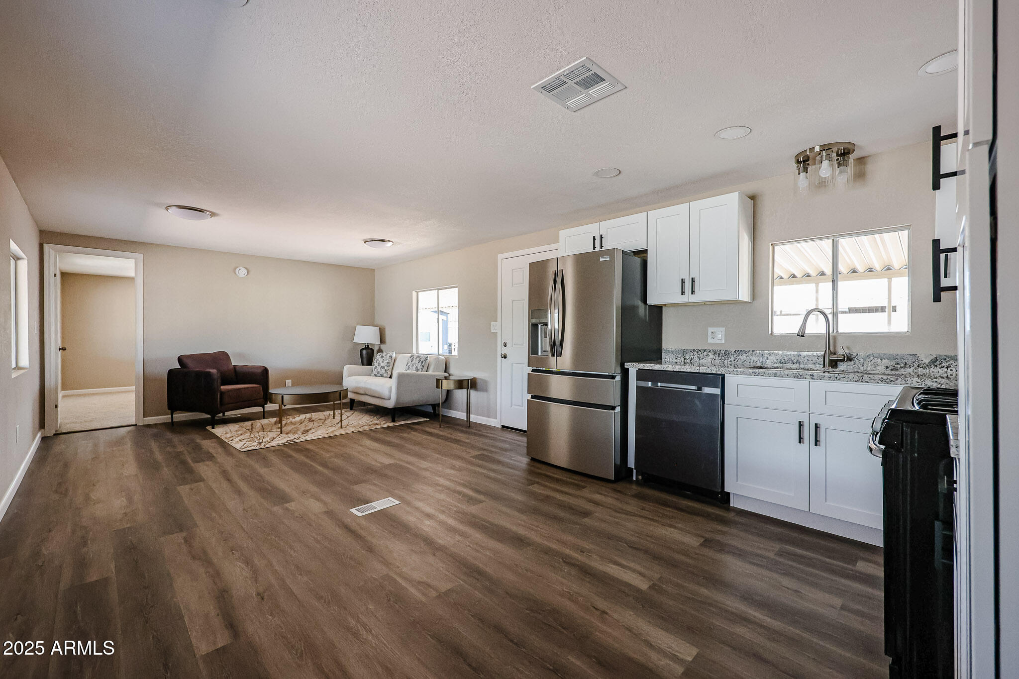 8600 East Broadway Road, Unit 53 Mesa, AZ 85208 - Photo 4 of 29 a kitchen with refrigerator and wooden floor