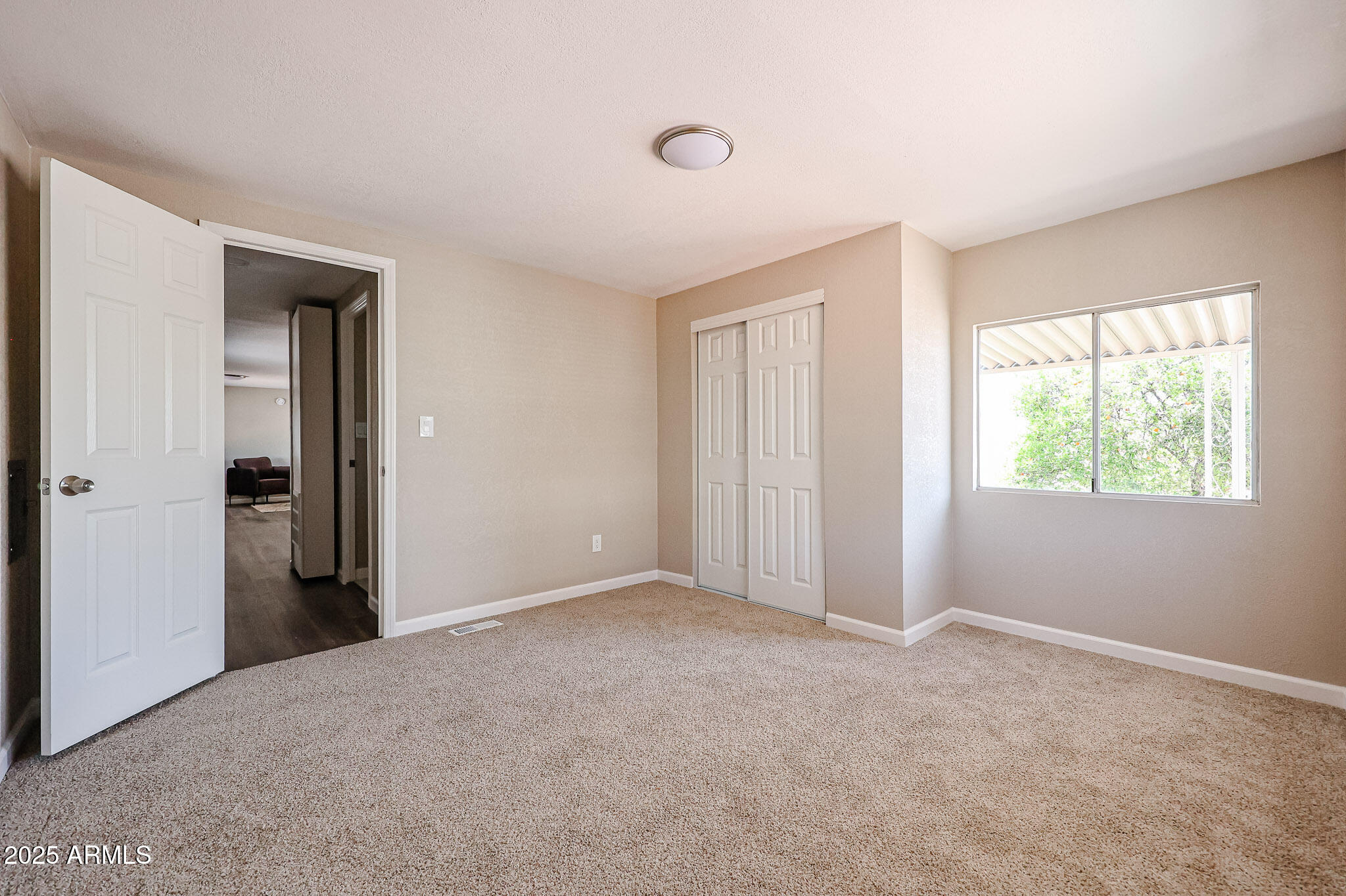 8600 East Broadway Road, Unit 53 Mesa, AZ 85208 - Photo 10 of 29 a view of an empty room with a window