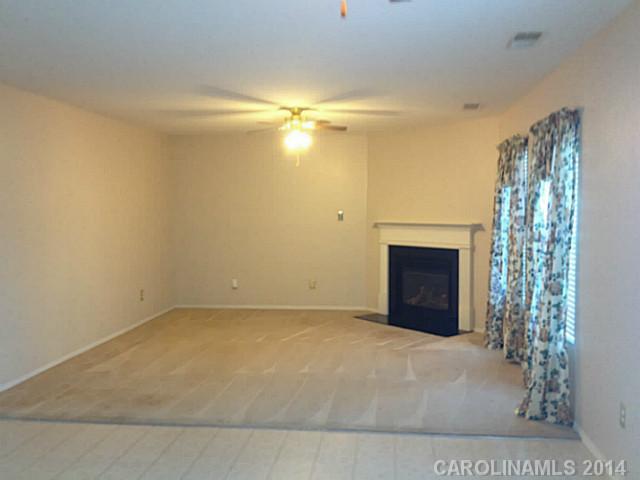 1632 Rustic Arch Way Huntersville, NC 28078 - Photo 5 of 16 a view of empty room with a fireplace and fan