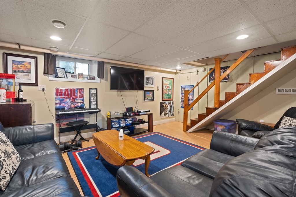 2 Woodbrier Road Topsfield, MA 01983 - Photo 25 of 29 a living room with furniture and a flat screen tv with wooden floor