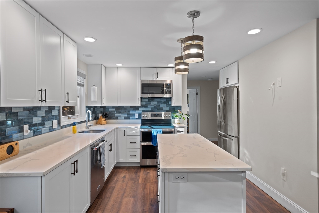 2 Woodbrier Road Topsfield, MA 01983 - Photo 4 of 29 a kitchen with a sink a counter top space stainless steel appliances and cabinets