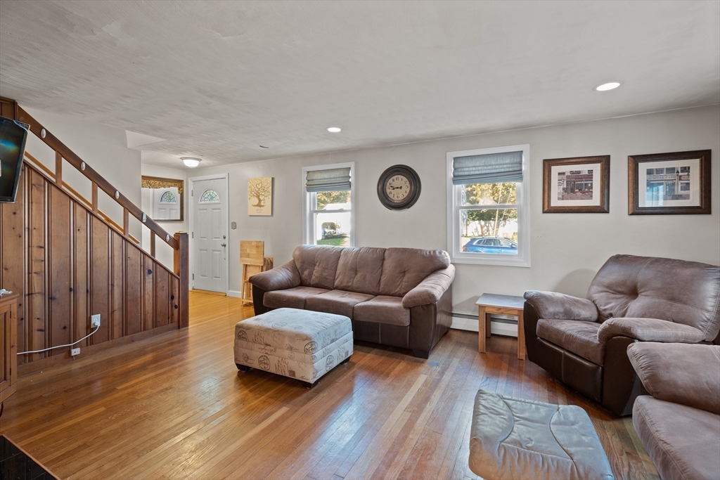 2 Woodbrier Road Topsfield, MA 01983 - Photo 9 of 29 a living room with couches and a large window with wooden floor
