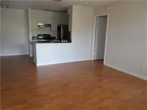 a kitchen with granite countertop a sink and a stove top oven