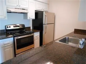 a kitchen with cabinets and steel stainless steel appliances