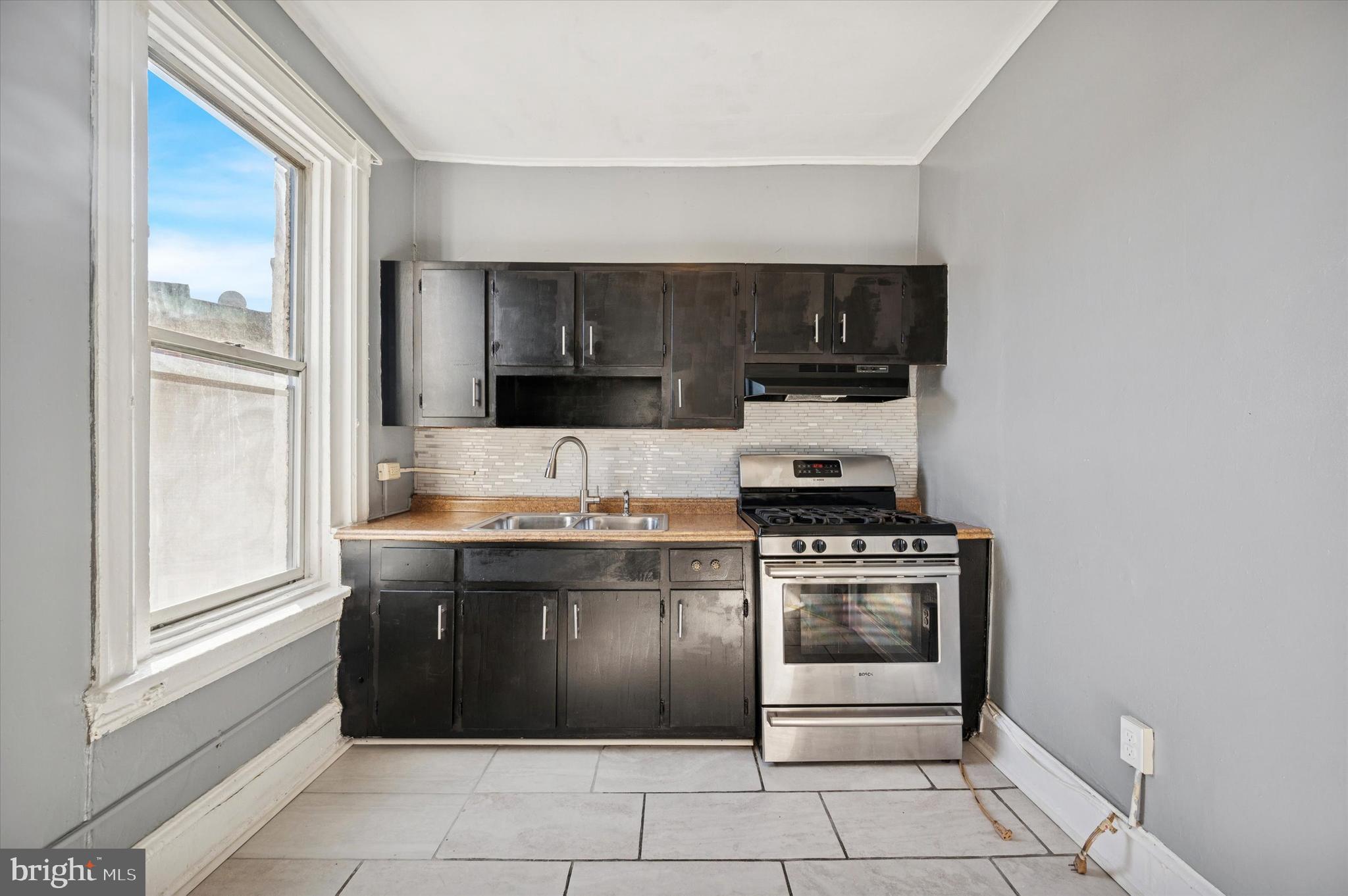 5262 Parkside Avenue Philadelphia, PA 19131 - Photo 10 of 14 a kitchen with a stove and a cabinet