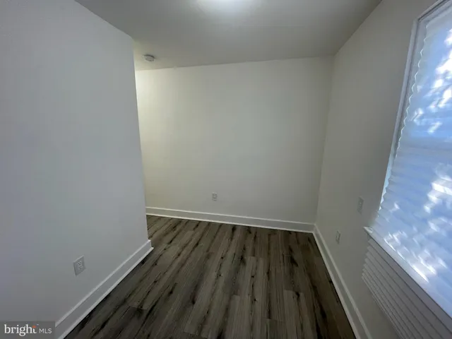 a view of wooden floor in a small bathroom