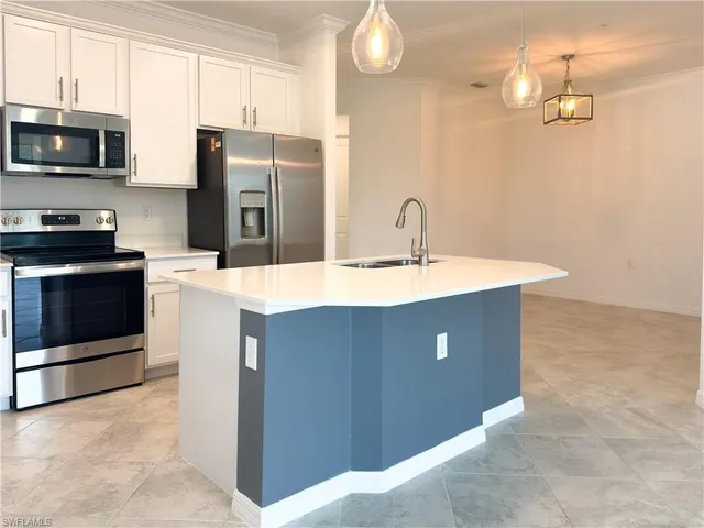 a kitchen with stainless steel appliances a sink stove and refrigerator