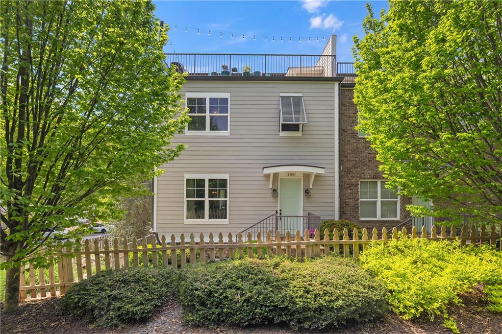 108 Canton Way Roswell, GA 30075 - Photo 1 of 46 a front view of a house with a garden