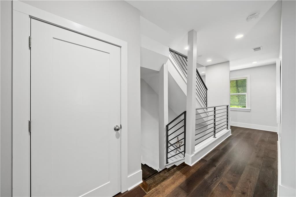108 Canton Way Roswell, GA 30075 - Photo 16 of 46 a view of a hallway with stairs and wooden floor