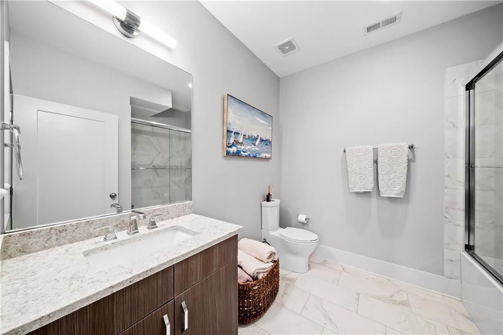 108 Canton Way Roswell, GA 30075 - Photo 26 of 46 a bathroom with a granite countertop sink a toilet and a mirror