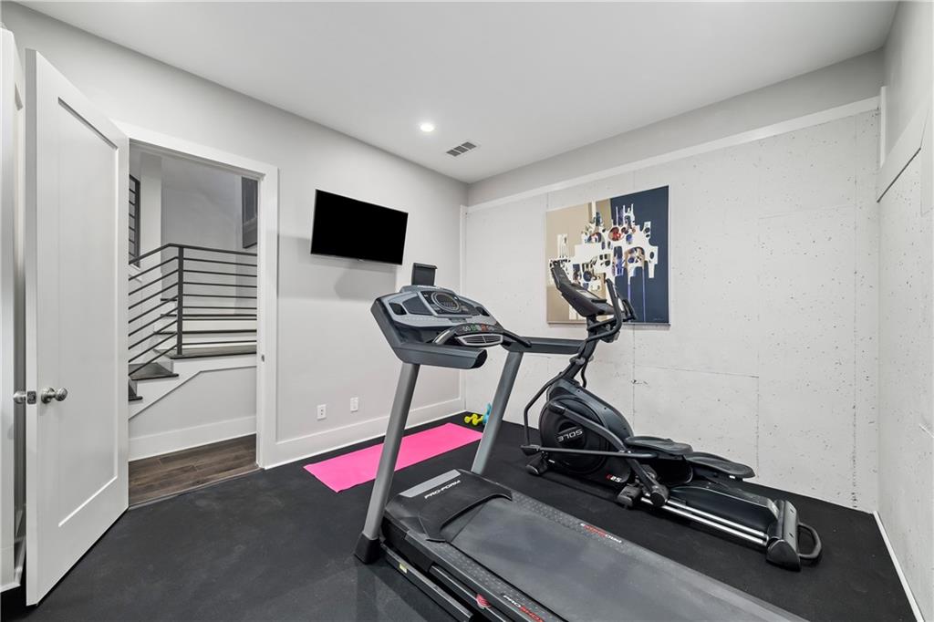 108 Canton Way Roswell, GA 30075 - Photo 38 of 46 a room with gym equipment and wooden floor
