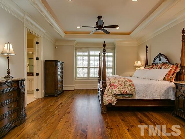 2921 Cone Manor Lane Raleigh, NC 27613 - Photo 12 of 25 a bedroom with a bed and wooden floor