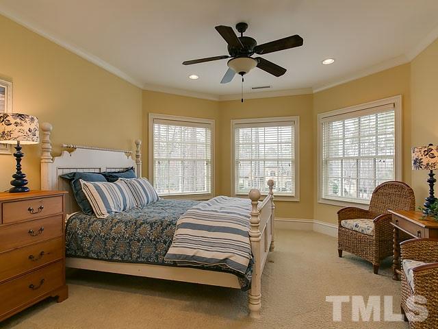 2921 Cone Manor Lane Raleigh, NC 27613 - Photo 17 of 25 a spacious bedroom with a bed a dresser and a window