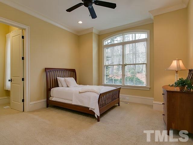 2921 Cone Manor Lane Raleigh, NC 27613 - Photo 19 of 25 a spacious bedroom with a bed and a window