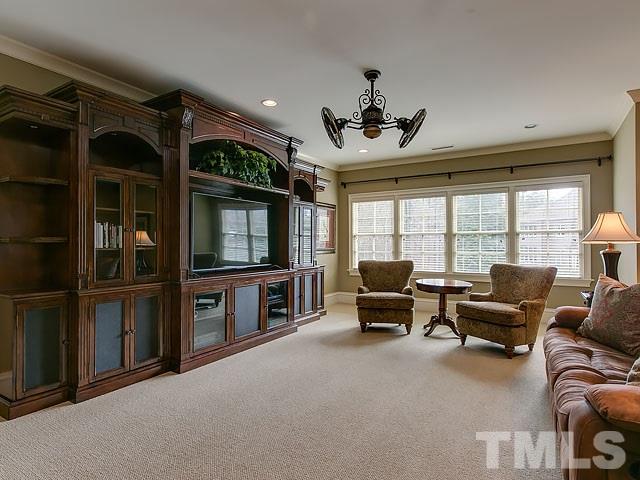 2921 Cone Manor Lane Raleigh, NC 27613 - Photo 20 of 25 a living room with furniture a flat screen tv and floor to ceiling window