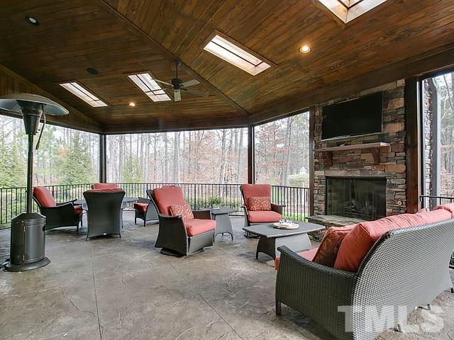 2921 Cone Manor Lane Raleigh, NC 27613 - Photo 22 of 25 a living room with furniture a flat screen tv and a large window