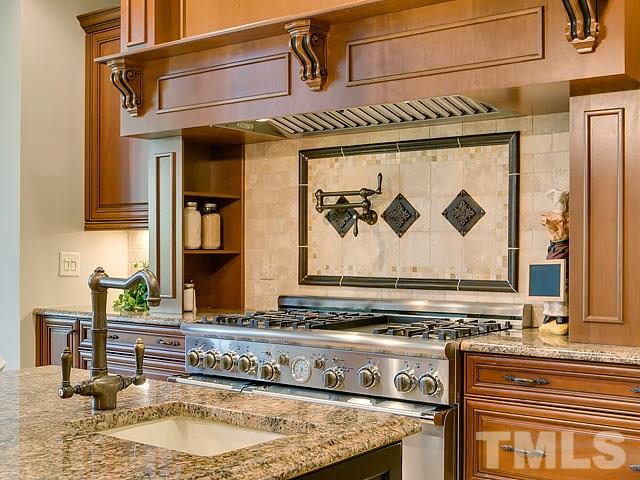 2921 Cone Manor Lane Raleigh, NC 27613 - Photo 5 of 25 a kitchen with a stove and a sink