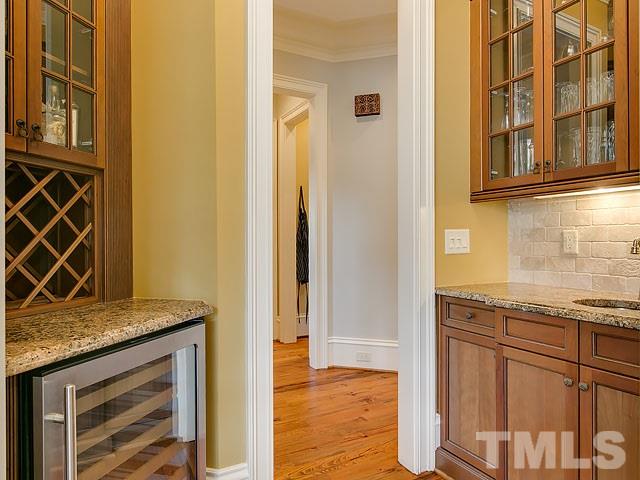 2921 Cone Manor Lane Raleigh, NC 27613 - Photo 7 of 25 a view of a granite countertop wooden cabinets and a window