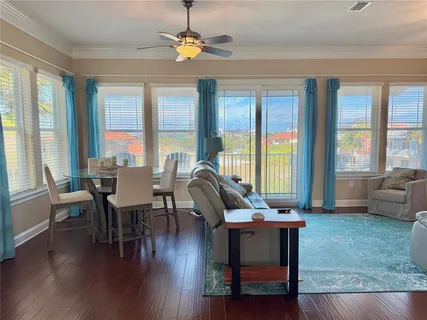 a living room with furniture and a ceiling fan