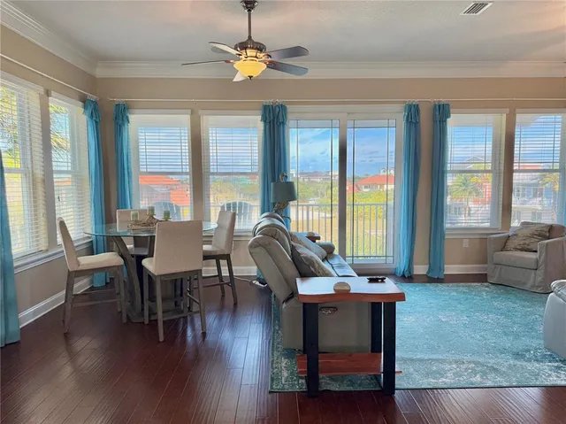 a living room with furniture and a ceiling fan