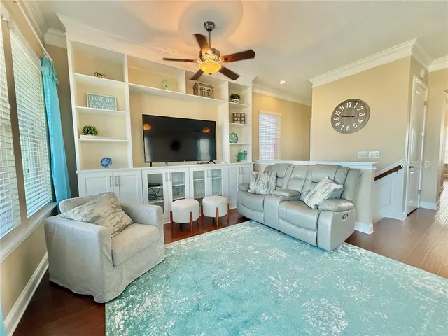 a living room with furniture and wooden floor