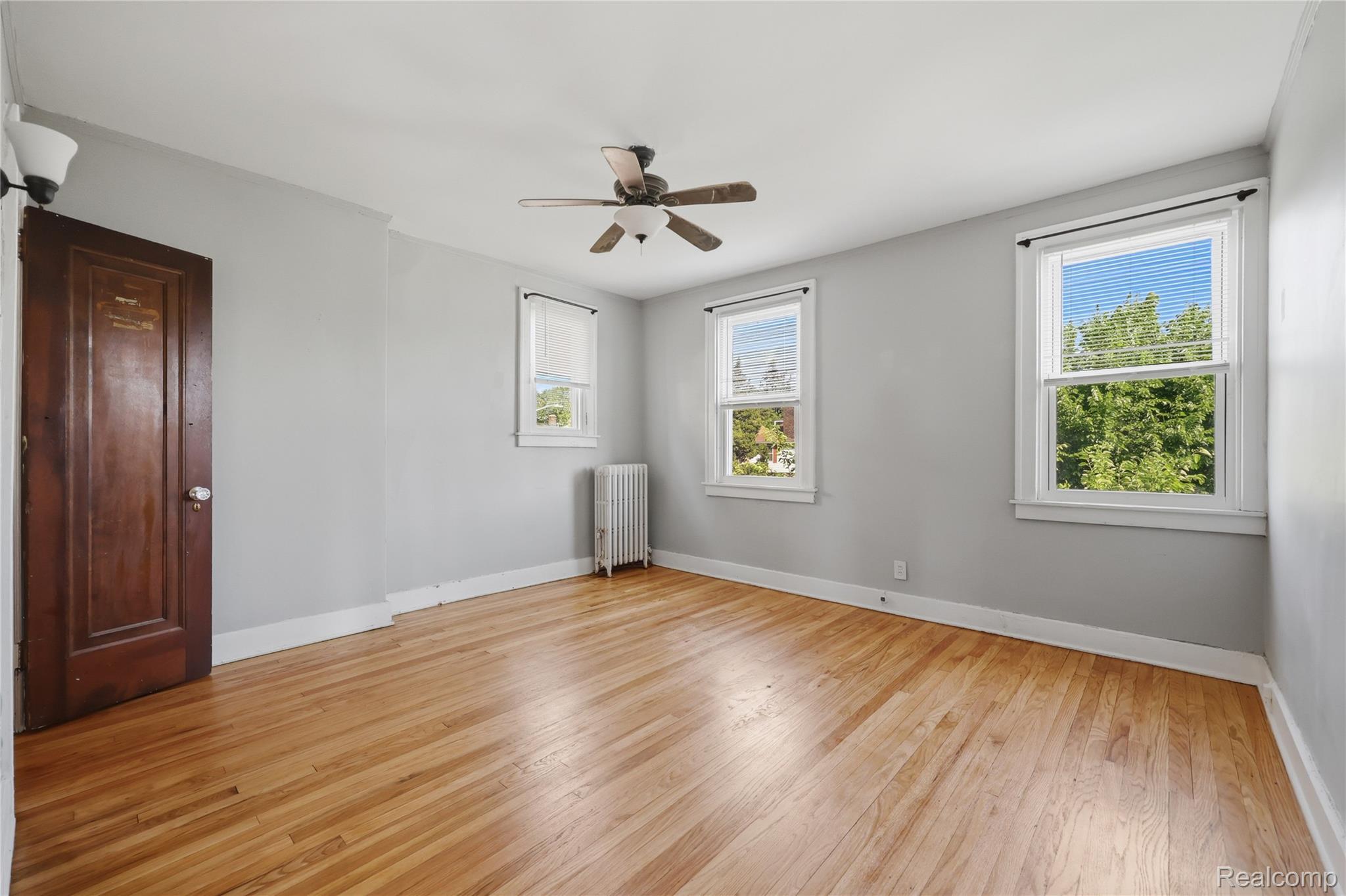 1945 Atkinson Street Detroit, MI 48206 - Photo 26 of 49 Light wood-finish flooring complemented by a ceiling fan