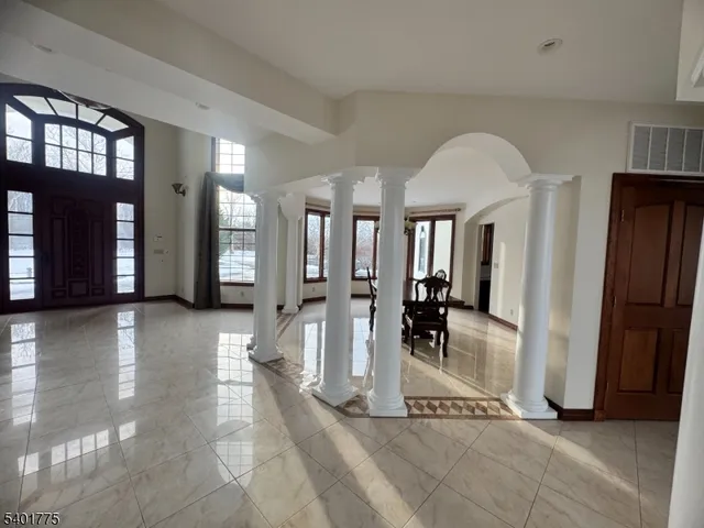 a view of a living room and entryway